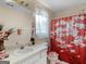 Bright bathroom with a sink and vanity and toilet with flowered pattern at 141 Wexford Ct, Stockbridge, GA 30281