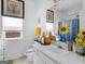 Bright bathroom with sunflower design and window with blinds at 141 Wexford Ct, Stockbridge, GA 30281