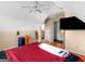 Bedroom with ceiling fan, a sloped ceiling, hardwood floors, and luggage at 141 Wexford Ct, Stockbridge, GA 30281