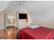Bedroom with ceiling fan, a sloped ceiling, hardwood floors, and a television at 141 Wexford Ct, Stockbridge, GA 30281
