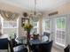 Cozy dining area with a glass-topped table, seating for four, and access to a bright outdoor patio at 141 Wexford Ct, Stockbridge, GA 30281