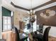Formal dining room with glass table, chandelier, and stylish decor, perfect for entertaining guests at 141 Wexford Ct, Stockbridge, GA 30281