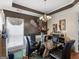 View of formal dining room with glass table, decorative window, and stylish chandelier at 141 Wexford Ct, Stockbridge, GA 30281