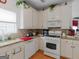Well-lit kitchen with white cabinets, granite countertops, and modern appliances at 141 Wexford Ct, Stockbridge, GA 30281