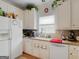 Bright kitchen featuring white cabinets, granite countertops, tile backsplash, and modern appliances at 141 Wexford Ct, Stockbridge, GA 30281