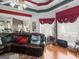 Bright living room featuring hardwood floors, decorative ceiling, large windows, and comfortable leather seating at 141 Wexford Ct, Stockbridge, GA 30281