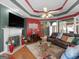 Comfortable living room with a fireplace, hardwood floors, custom ceiling, leather seating, and an open floor plan at 141 Wexford Ct, Stockbridge, GA 30281