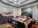 Well-decorated main bedroom with a tray ceiling, a ceiling fan, and carpet flooring at 141 Wexford Ct, Stockbridge, GA 30281