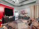 Spacious main bedroom with dark furniture, tv, and a glimpse into the luxurious bathroom at 141 Wexford Ct, Stockbridge, GA 30281