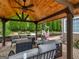 Outdoor living space under a gazebo with comfortable seating and wooden ceiling at 141 Wexford Ct, Stockbridge, GA 30281