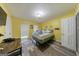 Bright bedroom with yellow walls, hardwood floors, and plenty of natural light at 105 N River Dr # G, Sandy Springs, GA 30350