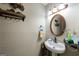 Cozy powder room featuring a pedestal sink, decorative mirror, and stylish wall decor at 105 N River Dr # G, Sandy Springs, GA 30350