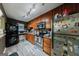 Efficient kitchen with stainless appliances, wooden cabinets, and space-saving stackable washer and dryer at 105 N River Dr # G, Sandy Springs, GA 30350