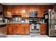 Functional kitchen with wood cabinets, stainless steel appliances, and ample counter space for cooking preparation at 105 N River Dr # G, Sandy Springs, GA 30350