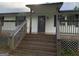 Cozy front porch with wooden stairs and railings leading to the entrance of the home at 276 Oakland Rd, Mcdonough, GA 30253