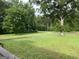 Expansive front yard with lush green grass, mature trees, and a view of the surrounding landscape at 276 Oakland Rd, Mcdonough, GA 30253