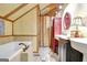 Bathroom featuring double sinks, a soaking tub, and tiled floors with wooden wall accents at 460 Morgan Mill Rd, Brooks, GA 30205
