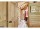 View of a bathroom featuring stone tile flooring, wood paneling, and an open doorway at 460 Morgan Mill Rd, Brooks, GA 30205