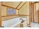 The bathroom features a soaking tub with tile surround and decorative wall art at 460 Morgan Mill Rd, Brooks, GA 30205