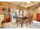 Charming dining area with a wooden table and chairs, open to the sunroom at 460 Morgan Mill Rd, Brooks, GA 30205