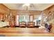 Bright dining area with wooden table and views to a sunroom and staircase at 460 Morgan Mill Rd, Brooks, GA 30205