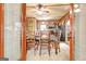 Cozy dining room with wood paneled walls, a dining table with chairs and a ceiling fan at 460 Morgan Mill Rd, Brooks, GA 30205