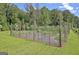 A fenced vegetable garden thrives on a sunny property, promising fresh produce at 460 Morgan Mill Rd, Brooks, GA 30205