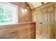 Hallway featuring wood accents, leading to other rooms, and providing natural light with a nearby window at 460 Morgan Mill Rd, Brooks, GA 30205