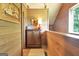 Upstairs hallway with a window and wood paneled walls, creating a warm and inviting space at 460 Morgan Mill Rd, Brooks, GA 30205