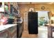 Cozy kitchen with black appliances, wooden accents, and an open view to the living area at 460 Morgan Mill Rd, Brooks, GA 30205