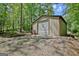Metal outbuilding with a closed garage door, offering secure storage and protection from the elements at 460 Morgan Mill Rd, Brooks, GA 30205