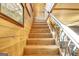 Well-lit wooden staircase with attractive wood paneling, offering a clear path to the upper floor at 460 Morgan Mill Rd, Brooks, GA 30205