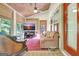 Inviting sunroom featuring wood ceiling, natural light, comfortable seating and a vibrant pink rug at 460 Morgan Mill Rd, Brooks, GA 30205