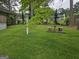 Expansive backyard featuring lush lawn, mature trees, a picnic table, and a vintage bird feeder at 529 Valley Woods Se Cir, Conyers, GA 30094