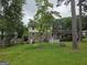 Spacious backyard with lush green lawn, trees, picnic table, and partial view of the home's exterior at 529 Valley Woods Se Cir, Conyers, GA 30094