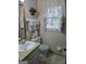 Cozy bathroom with a sink, toilet, decorative towels and natural light from the window at 529 Valley Woods Se Cir, Conyers, GA 30094