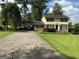 Traditional two-story home with yellow siding, black shutters, a carport, and a well-maintained front lawn at 529 Valley Woods Se Cir, Conyers, GA 30094