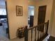 Upstairs hallway featuring wood railing and trim at 529 Valley Woods Se Cir, Conyers, GA 30094