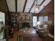 Inviting living room with a brick fireplace, wood-paneled walls, and a vaulted ceiling with exposed beams at 529 Valley Woods Se Cir, Conyers, GA 30094