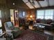 Cozy living room featuring wood paneling, a ceiling fan, and comfortable seating with an adjacent dining room view at 529 Valley Woods Se Cir, Conyers, GA 30094