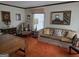 Comfortable living room with bright orange carpet, vintage furniture, and traditional decor accents at 529 Valley Woods Se Cir, Conyers, GA 30094