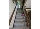 Carpeted staircase with wood railing and trim at 529 Valley Woods Se Cir, Conyers, GA 30094