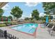 Sparkling community pool with lounge chairs and mature trees at 119 Holiday Road, Unit 301 Rd # 301, Buford, GA 30518
