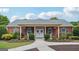 Charming brick home with double doors, rocking chairs, and lush landscaping at 119 Holiday Road, Unit 301 Rd # 301, Buford, GA 30518