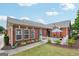 Beautiful brick home with manicured lawn and a charming patio area at 119 Holiday Road, Unit 301 Rd # 301, Buford, GA 30518