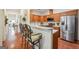Stylish kitchen with stainless steel appliances, breakfast bar, and modern fixtures at 119 Holiday Road, Unit 301 Rd # 301, Buford, GA 30518