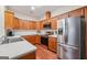 Open kitchen with wood cabinets, stainless steel appliances, and modern countertops at 119 Holiday Road, Unit 301 Rd # 301, Buford, GA 30518