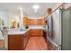 Updated kitchen features wood cabinets, stainless steel appliances, and hardwood flooring at 119 Holiday Road, Unit 301 Rd # 301, Buford, GA 30518