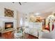 Cozy living room with a fireplace and hardwood floors flowing to the kitchen at 119 Holiday Road, Unit 301 Rd # 301, Buford, GA 30518