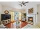 Bright living room with fireplace, hardwood floors, and a large window with curtains at 119 Holiday Road, Unit 301 Rd # 301, Buford, GA 30518